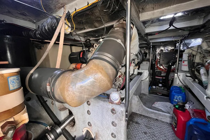  Yacht Photos Pics Engine room of a 2001 Silverton 42C boat, showcasing mechanical components and wiring.