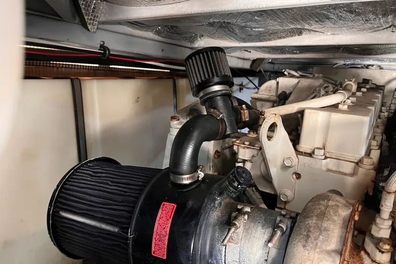  Yacht Photos Pics Engine compartment of a 2001 Silverton 42C boat, showcasing mechanical components and filters.