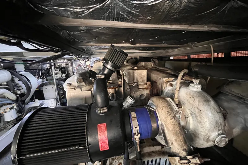  Yacht Photos Pics Engine compartment of a 2001 Silverton 42C boat, showcasing mechanical components.