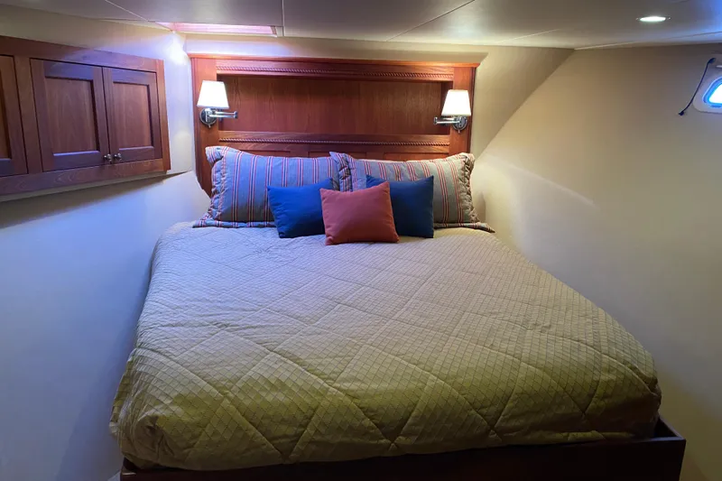 Nomad Yacht Photos Pics Cozy bedroom in 2003 Northern Marine 57 Raised Pilothouse yacht with elegant bedding.