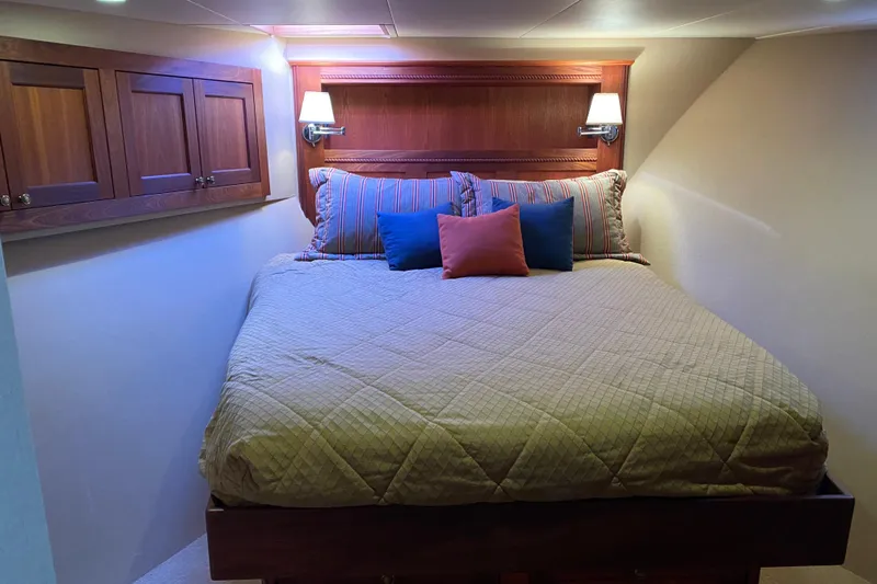 Nomad Yacht Photos Pics Cozy bedroom in 2003 Northern Marine 57 Raised Pilothouse yacht with elegant wood accents.