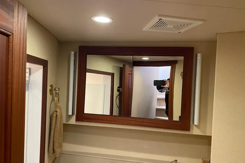 Nomad Yacht Photos Pics Bathroom mirror in 2003 Northern Marine 57 Raised Pilothouse yacht, reflecting stairs and interior.