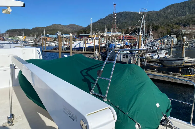 Nomad Yacht Photos Pics 2003 Northern Marine 57 Raised Pilothouse yacht docked at a scenic marina.