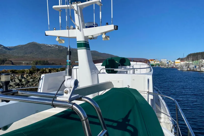 Nomad Yacht Photos Pics 2003 Northern Marine 57 Raised Pilothouse yacht docked in scenic marina with mountains.