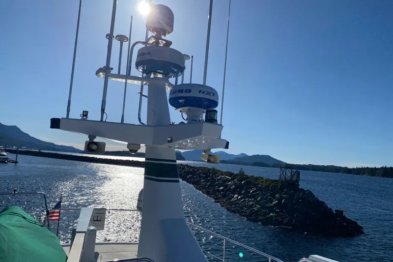Nomad Yacht Photos Pics Northern Marine 57 Raised Pilothouse yacht, 2003, with radar equipment, on a sunny day by the water.