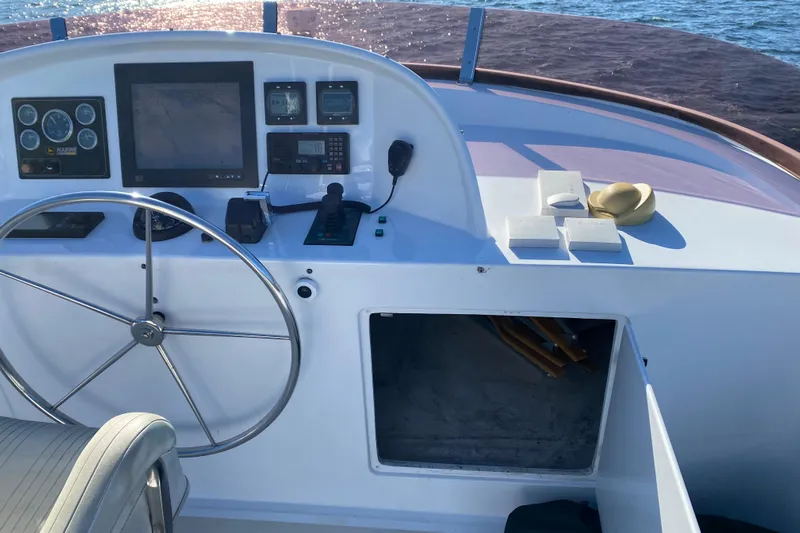 Nomad Yacht Photos Pics Pilothouse of 2003 Northern Marine 57 Raised Pilothouse yacht with steering wheel and navigation equipment.