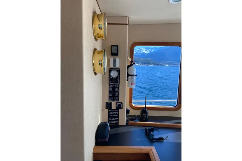 Nomad Yacht Photos Pics Interior of 2003 Northern Marine 57 Raised Pilothouse with ocean view and nautical instruments.