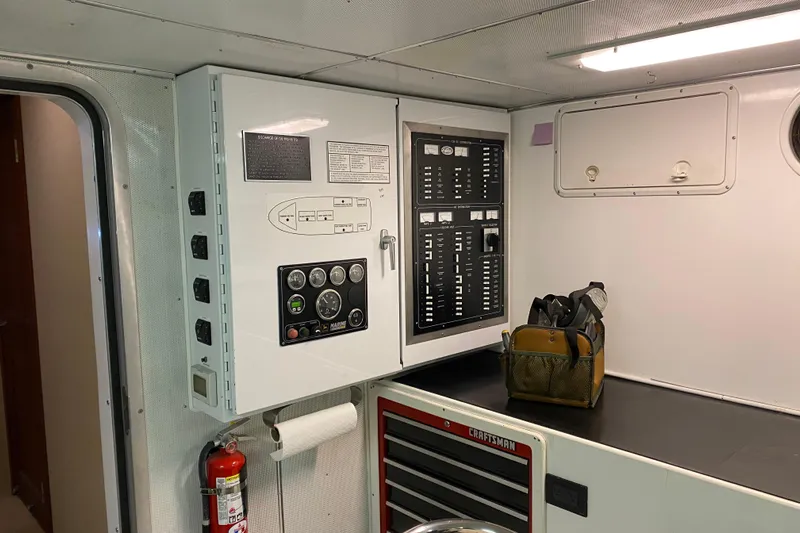 Nomad Yacht Photos Pics Control panel and tool storage in 2003 Northern Marine 57 Raised Pilothouse yacht interior.