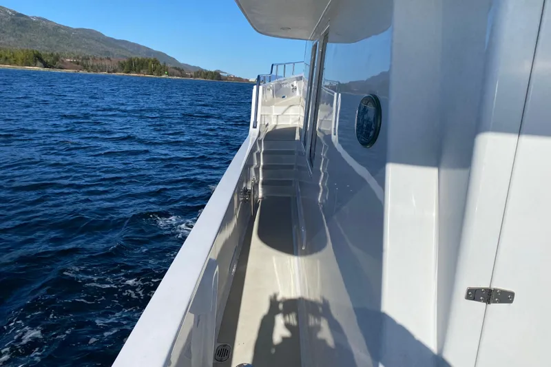 Nomad Yacht Photos Pics Side deck of 2003 Northern Marine 57 Raised Pilothouse yacht on open water.