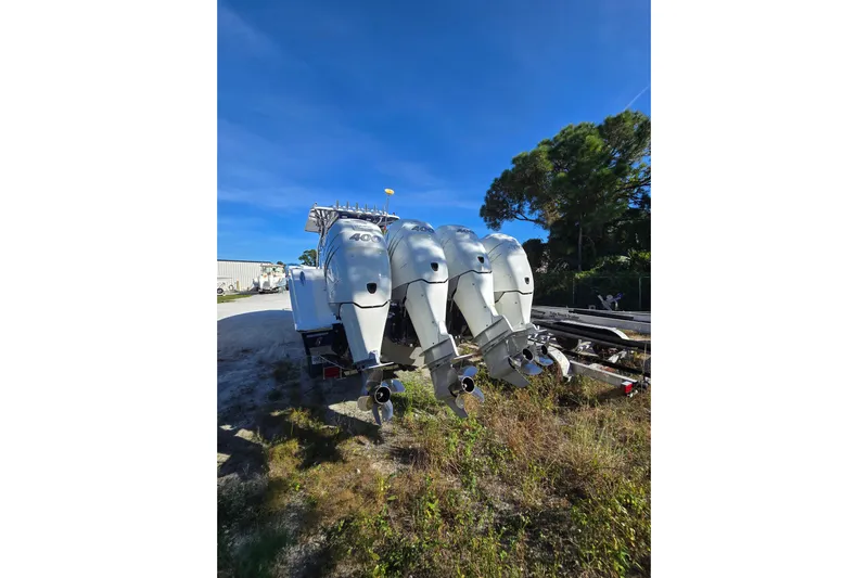  Yacht Photos Pics 2013 Invincible 42 Open Fisherman with triple outboard engines, parked outdoors.