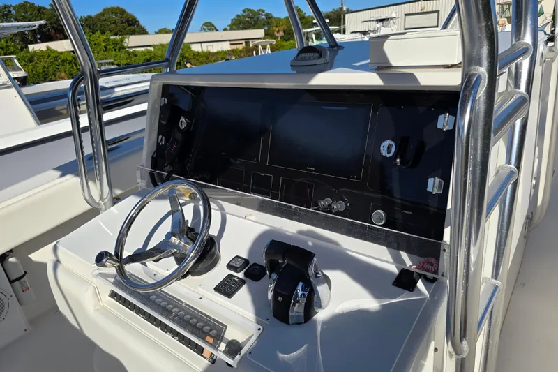  Yacht Photos Pics 2013 Invincible 42 Open Fisherman boat console with steering wheel and controls.