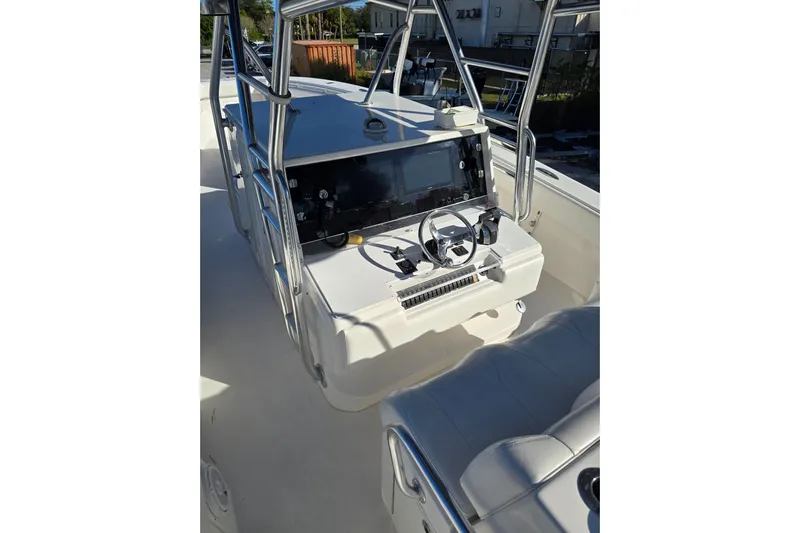  Yacht Photos Pics 2013 Invincible 42 Open Fisherman boat console with steering wheel and navigation equipment.