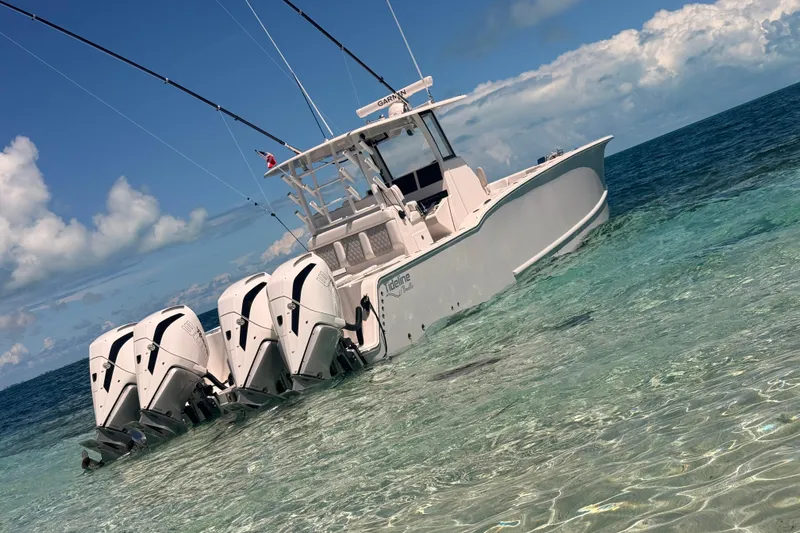  Yacht Photos Pics 2024 Tideline 365 boat with four engines in clear ocean water.