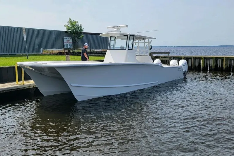  Yacht Photos Pics 2024 Tideline 365 boat docked by the water, featuring a sleek design and modern build.