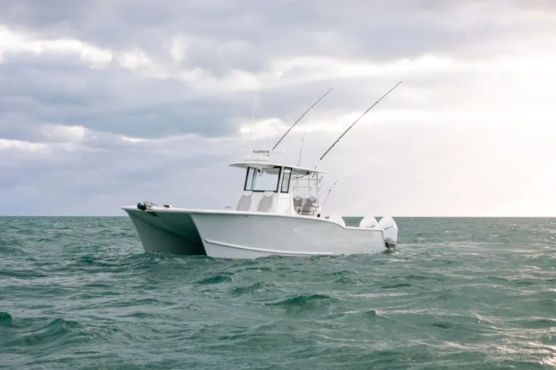  Yacht Photos Pics 2024 Tideline 365 boat on open sea under cloudy sky.