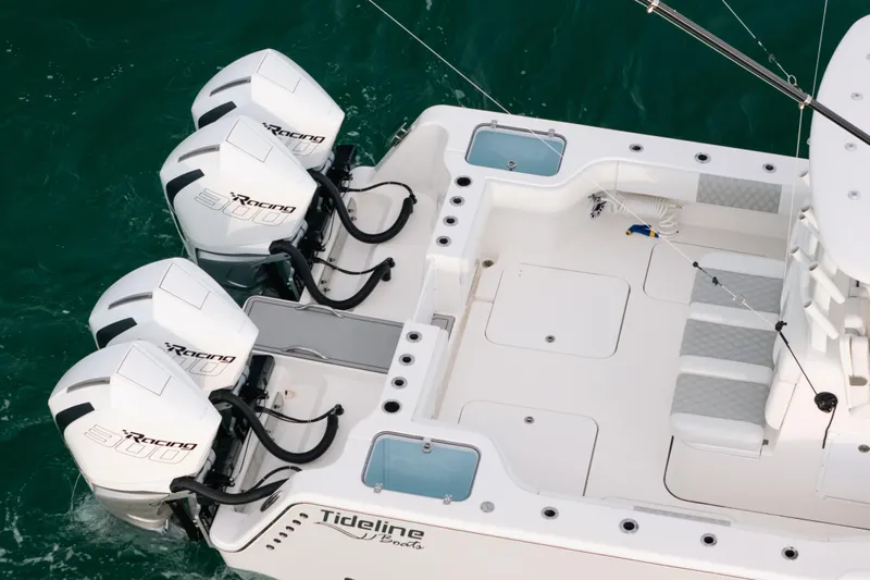  Yacht Photos Pics 2024 Tideline 365 boat with triple outboard engines on turquoise water.
