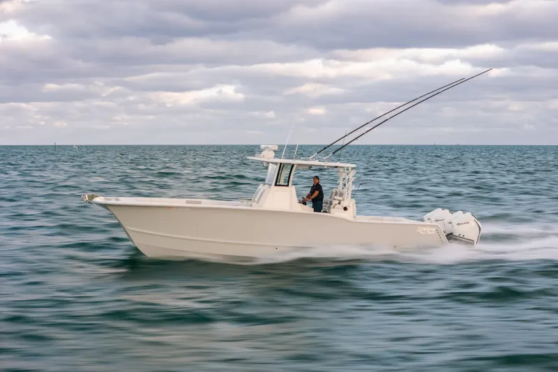  Yacht Photos Pics 2024 Tideline 365 boat cruising on open water under cloudy skies.