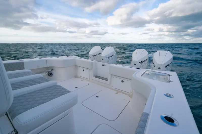  Yacht Photos Pics 2024 Tideline 365 boat with quad engines on open sea under cloudy sky.