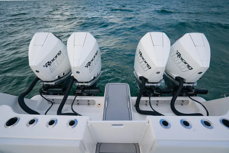  Yacht Photos Pics 2024 Tideline 365 boat with four powerful outboard engines on open water.