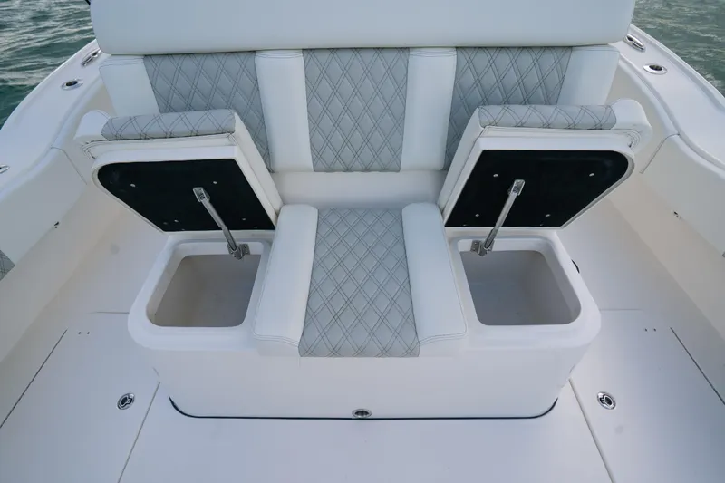  Yacht Photos Pics 2024 Tideline 365 boat seating with storage compartments, featuring diamond-patterned upholstery.