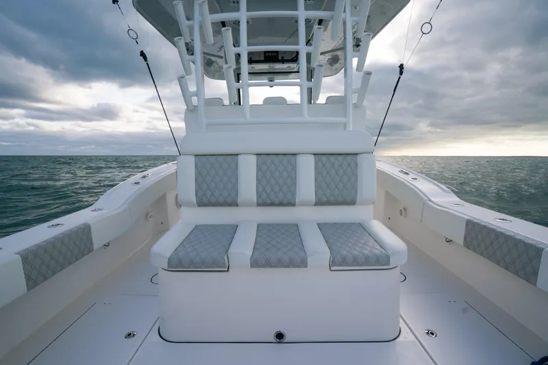  Yacht Photos Pics 2024 Tideline 365 boat interior with cushioned seating, ocean view, and cloudy sky.