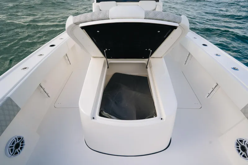  Yacht Photos Pics 2024 Tideline 365 boat with open storage compartment on deck, surrounded by ocean water.