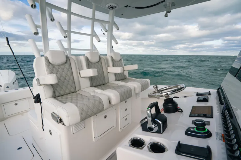  Yacht Photos Pics 2024 Tideline 365 boat interior with luxury seating and advanced controls on open water.