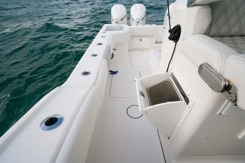 Yacht Photos Pics 2024 Tideline 365 boat interior with white seating and storage, on open water.