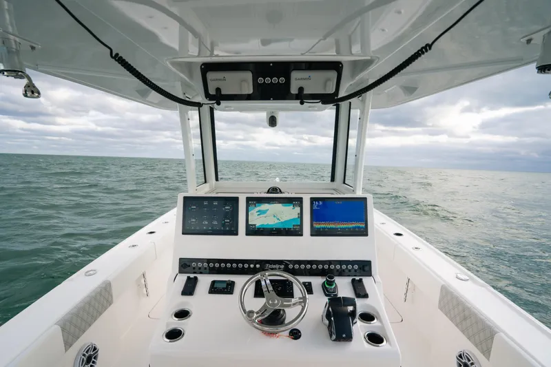  Yacht Photos Pics 2024 Tideline 365 boat dashboard with navigation screens on open sea.