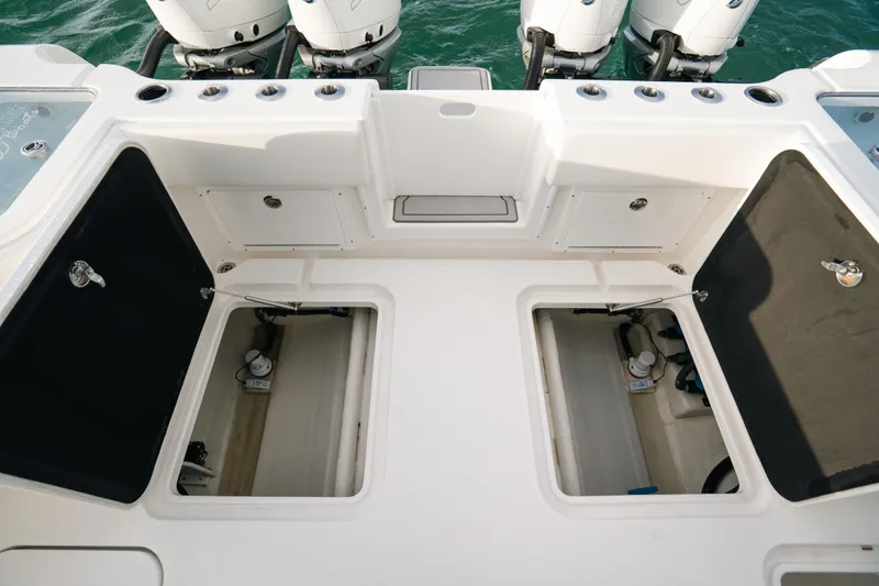  Yacht Photos Pics 2024 Tideline 365 boat deck with storage compartments and multiple outboard engines.