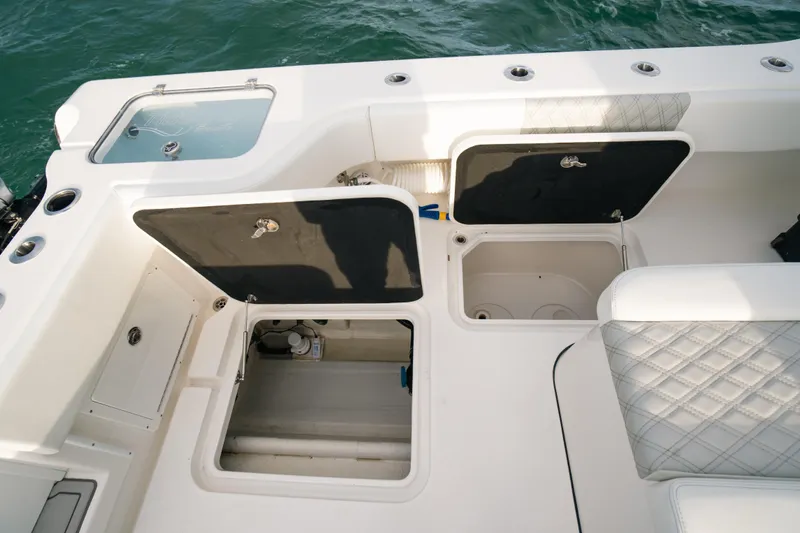  Yacht Photos Pics 2024 Tideline 365 boat deck with open storage compartments and quilted seating.