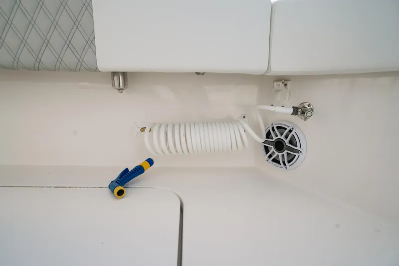  Yacht Photos Pics 2024 Tideline 365 boat interior with coiled hose and speaker detail.