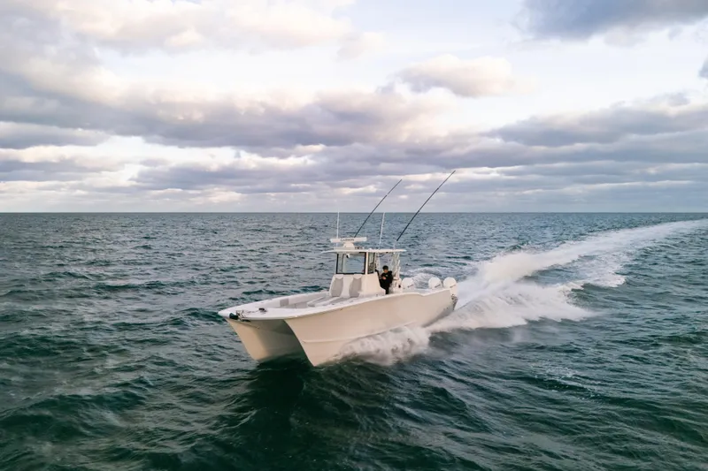  Yacht Photos Pics 2024 Tideline 365 boat cruising on open ocean under cloudy sky.