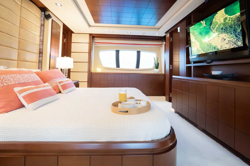 Koukles Yacht Photos Pics Luxurious bedroom interior of 2008 Azimut 95 E yacht with elegant decor and modern amenities.