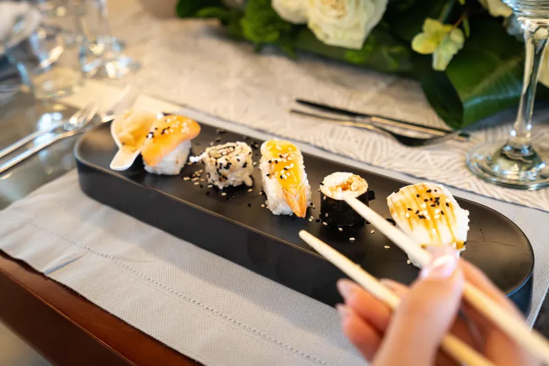 Koukles Yacht Photos Pics Sushi platter on luxury Azimut 95 E yacht, 2008 model, with elegant table setting.