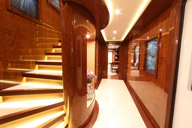 Elada Yacht Photos Pics Luxurious interior of 2014 Bilgin 147 yacht with elegant wood paneling and illuminated staircase.