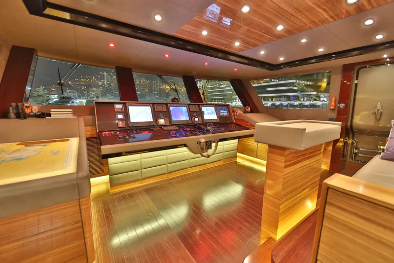 Elada Yacht Photos Pics Luxurious interior of 2014 Bilgin 147 yacht with modern navigation equipment and wood finishes.