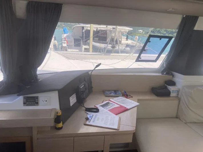 Knot On Call Yacht Photos Pics Interior of 2018 Fountaine Pajot Helia 44 Evolution catamaran with documents on table.