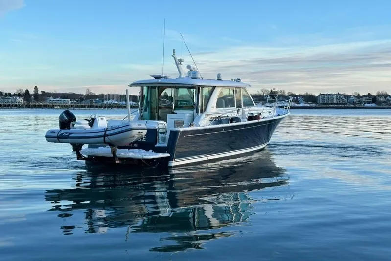 Cellibrate Yacht Photos Pics 2020 Sabre 45 Salon Express yacht on calm water, scenic background.
