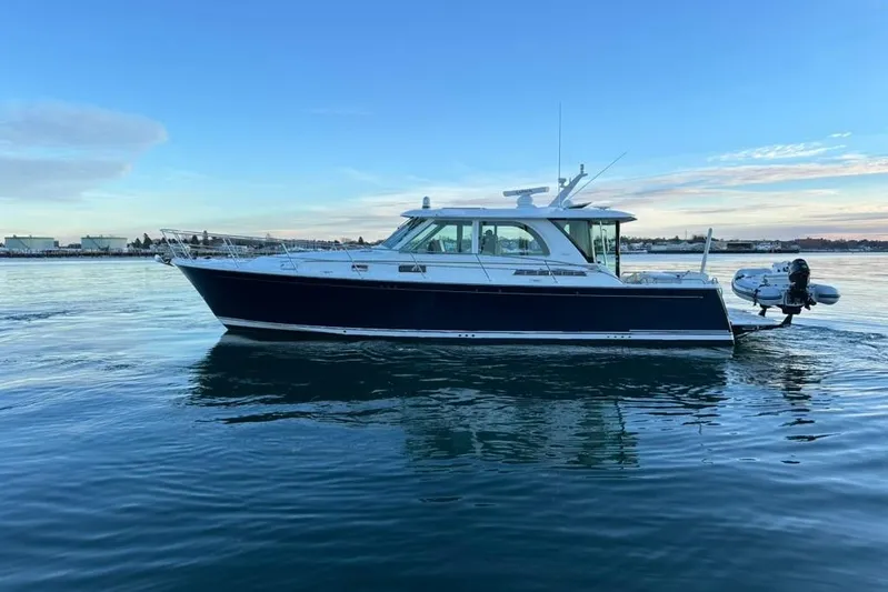 Cellibrate Yacht Photos Pics 2020 Sabre 45 Salon Express yacht cruising on calm waters at sunset.