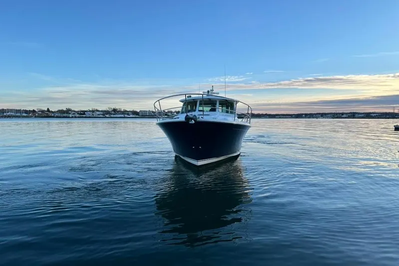 Cellibrate Yacht Photos Pics 2020 Sabre 45 Salon Express yacht on calm water at sunset.