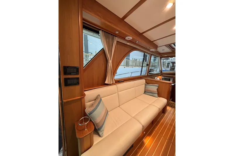 Cellibrate Yacht Photos Pics Interior of 2020 Sabre 45 Salon Express yacht with elegant wood finish and plush seating.