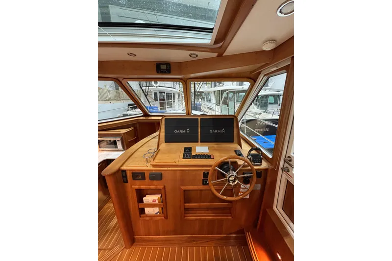 Cellibrate Yacht Photos Pics 2020 Sabre 45 Salon Express helm with Garmin navigation, wooden interior, and panoramic windows.