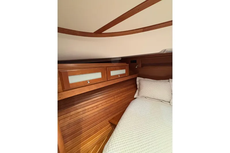 Cellibrate Yacht Photos Pics 2020 Sabre 45 Salon Express cabin interior with wooden paneling and cozy bedding.