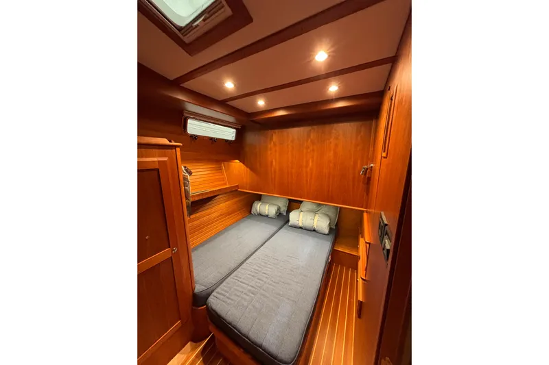 Cellibrate Yacht Photos Pics 2020 Sabre 45 Salon Express cabin with twin beds, wooden interior, and soft lighting.