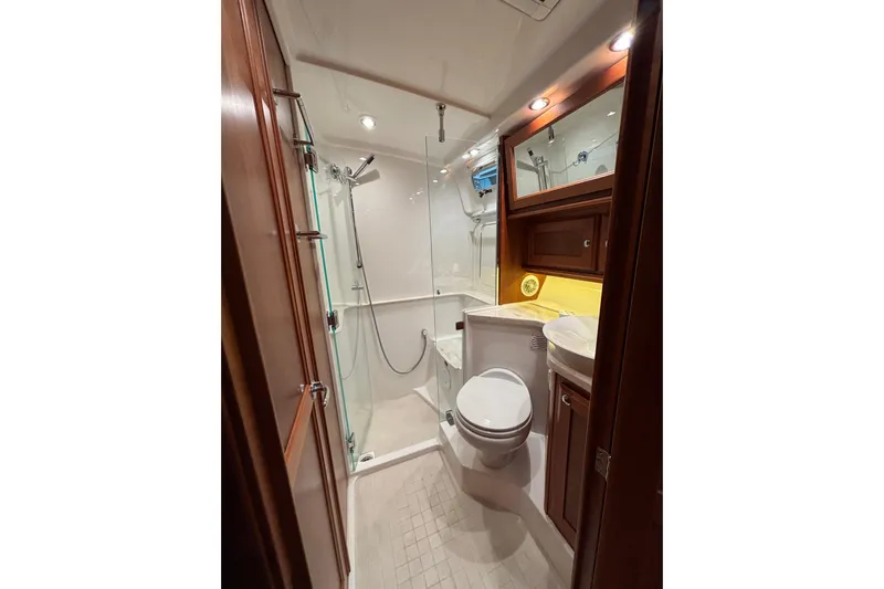 Cellibrate Yacht Photos Pics Luxurious bathroom in 2020 Sabre 45 Salon Express yacht with shower and wooden cabinetry.