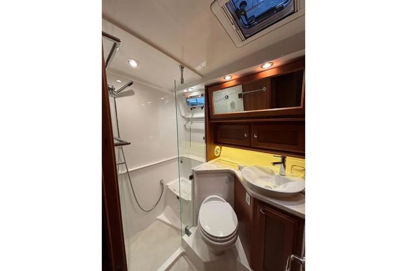 Cellibrate Yacht Photos Pics Luxurious bathroom in 2020 Sabre 45 Salon Express yacht with modern fixtures and wood accents.