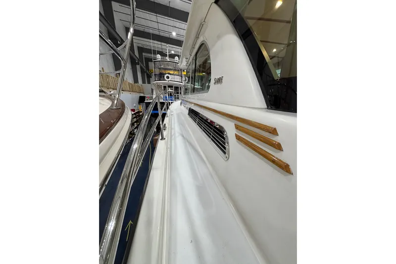 Cellibrate Yacht Photos Pics 2020 Sabre 45 Salon Express yacht in showroom, showcasing sleek design and polished railings.