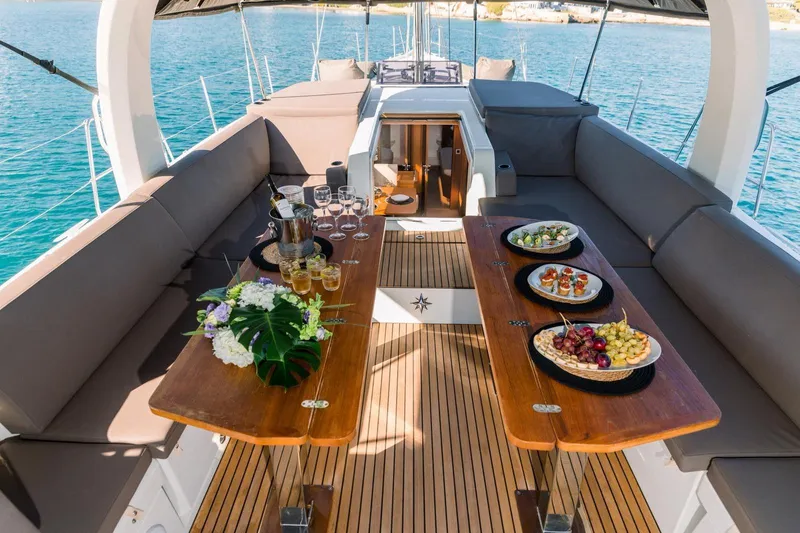 Euphoria Yacht Photos Pics Luxurious Jeanneau 60 yacht deck with elegant dining setup, 2021 model.