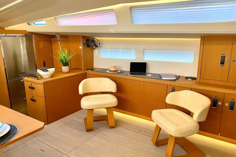 Euphoria Yacht Photos Pics Luxurious interior of 2021 Jeanneau 60 yacht with modern seating and elegant wood finishes.